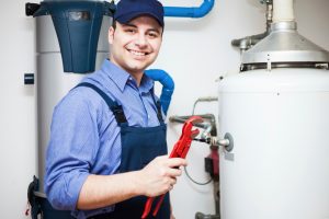 a plumber smiles as he works on a plumbing service in allendale