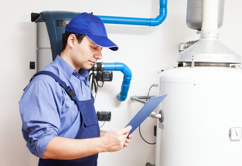 plumber performing water heater maintenance in bergen county