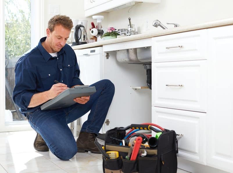 image of a teaneck nj plumber performing kitchen plumbing repairs